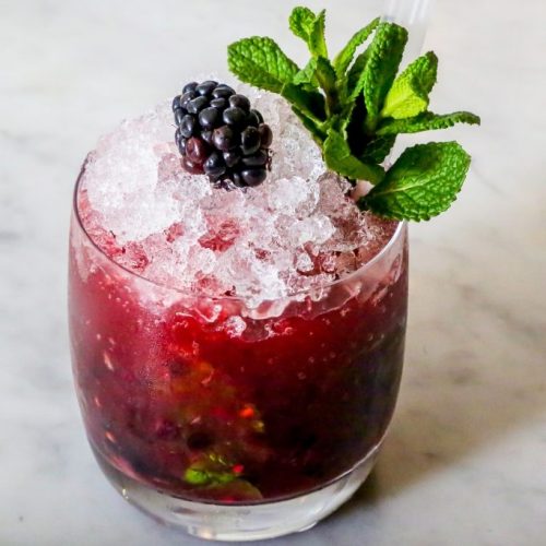 The Black Berry Beast, a signature cocktail with fresh berry, mint and licorice flavours, using Absinthe and Chambord forest berry liquor. 