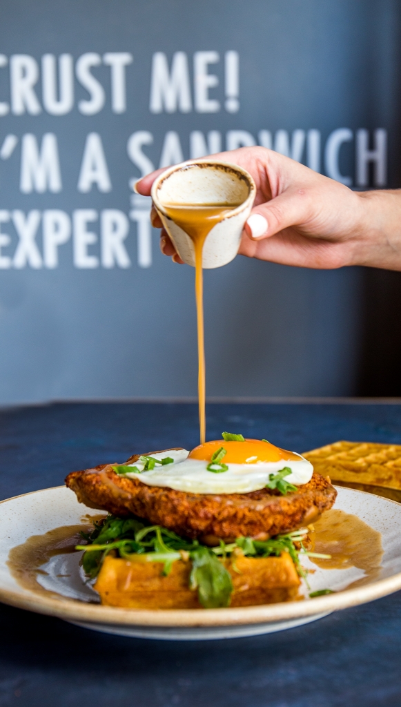 CRUNCHY CHICKEN WAFFLE A soft waffle served with a crunchy marinated chicken breast, baby rocca, fried egg, spring onions, hot cream and gravy sauce. 50AED (4)